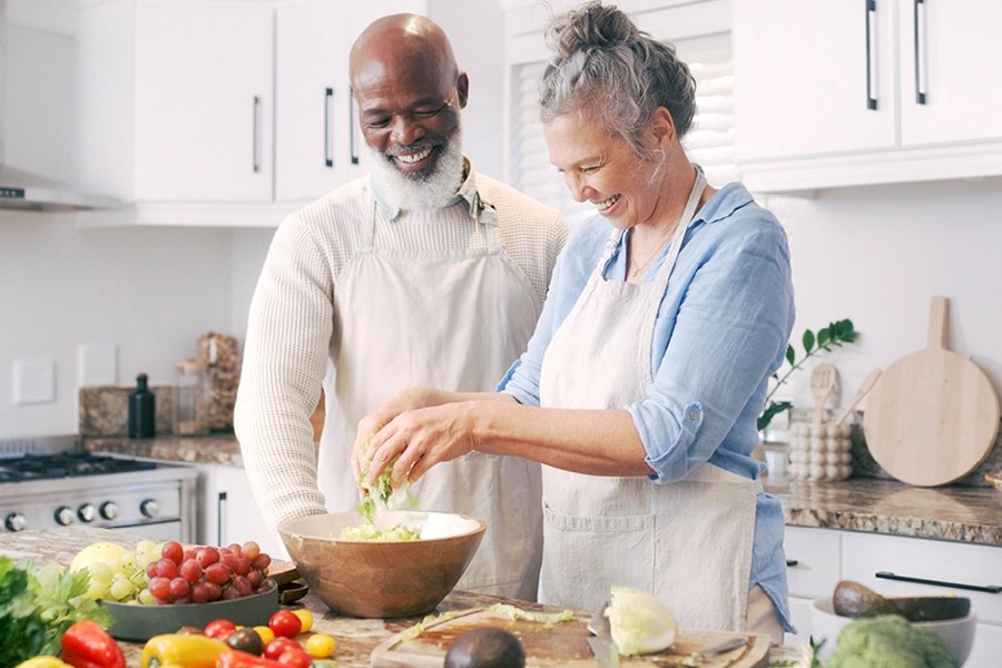 Couple preparing salad
