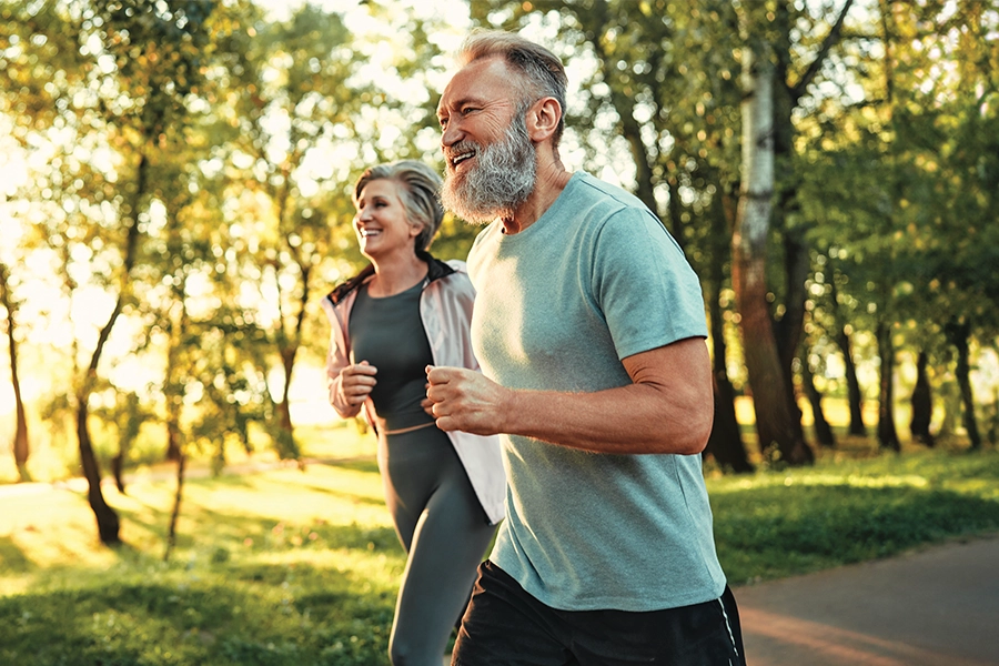 Couple jogging in wooded area